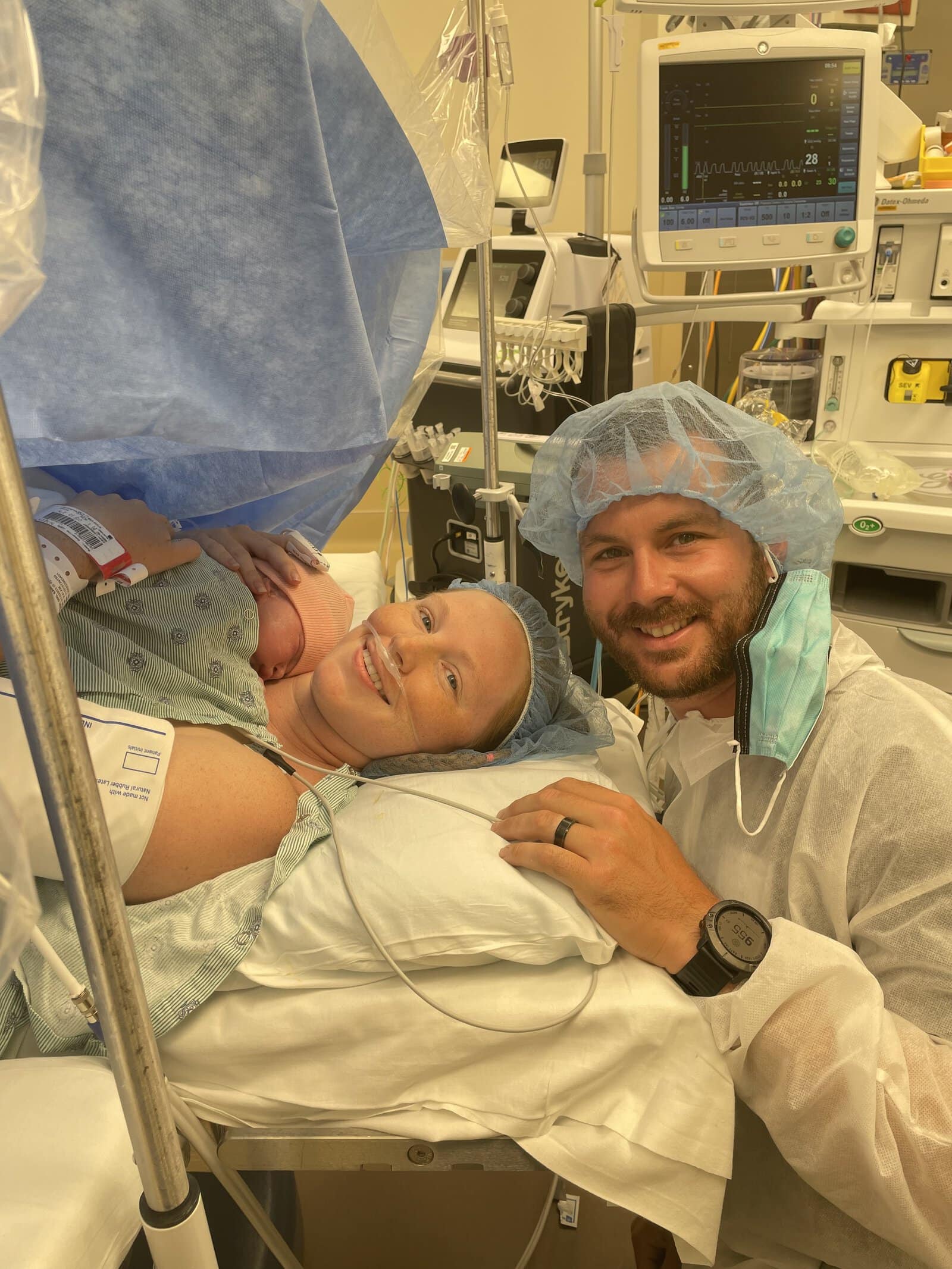 mom dad and baby in operating room