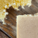 natural ingredients, oats and honey soap with a honeycomb and oats on a wood table