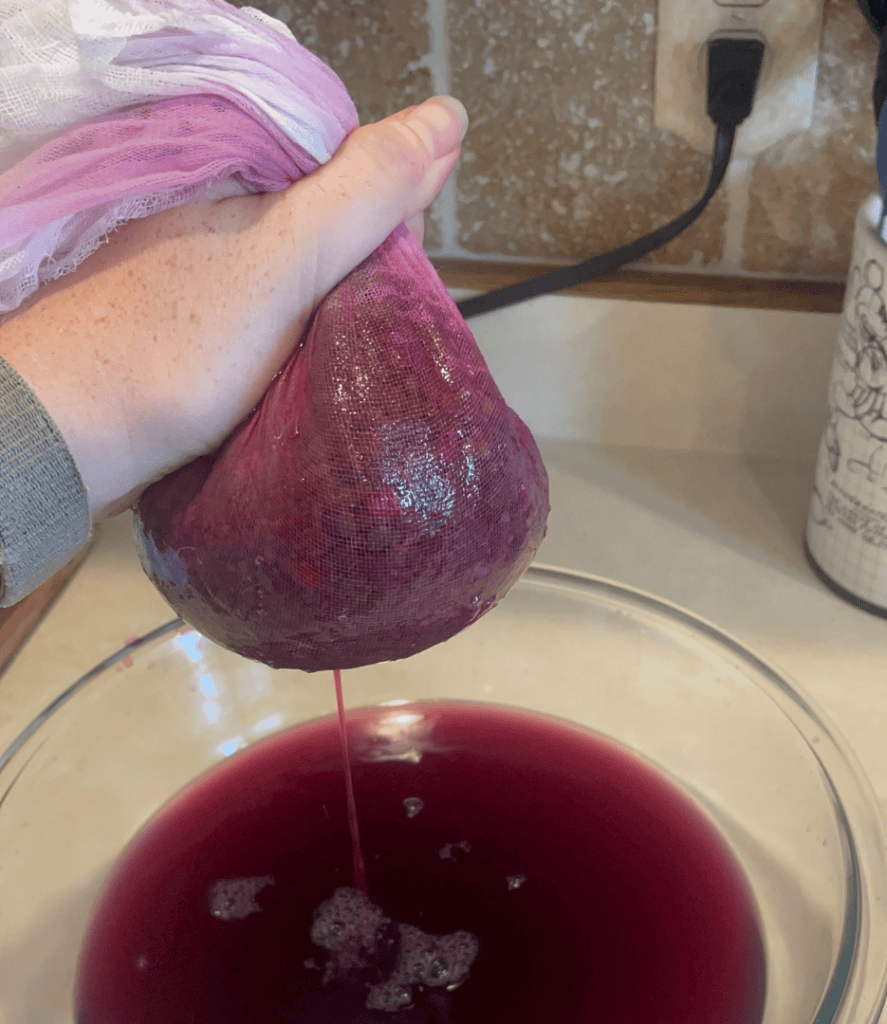squeezing elderberry juice