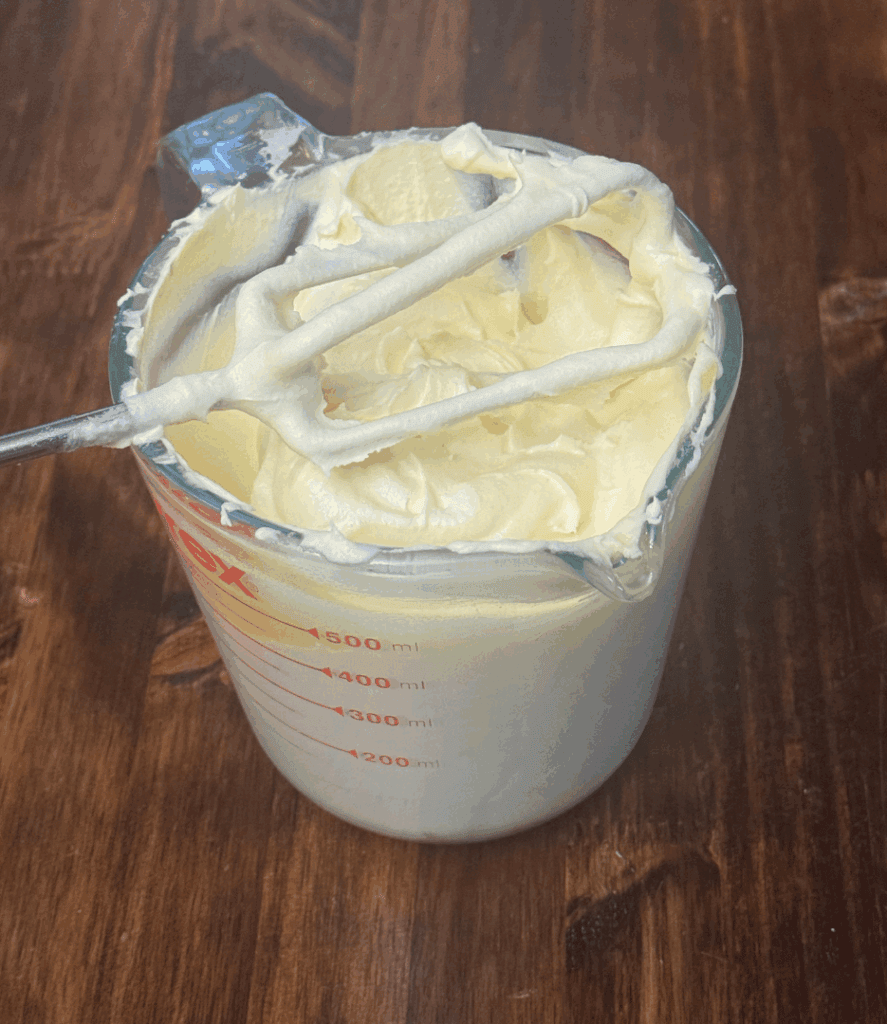 calendula tallow baby balm in measuring cup