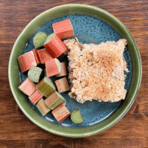 rhubarb crumble with rhubarb pieces on a plate