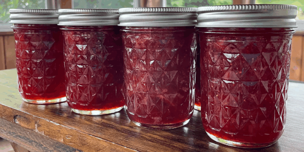 Delicious strawberry rhubarb jam in jars after water bath canning