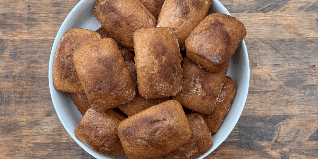 mini loaves of apple cider donut bread in a white bowl