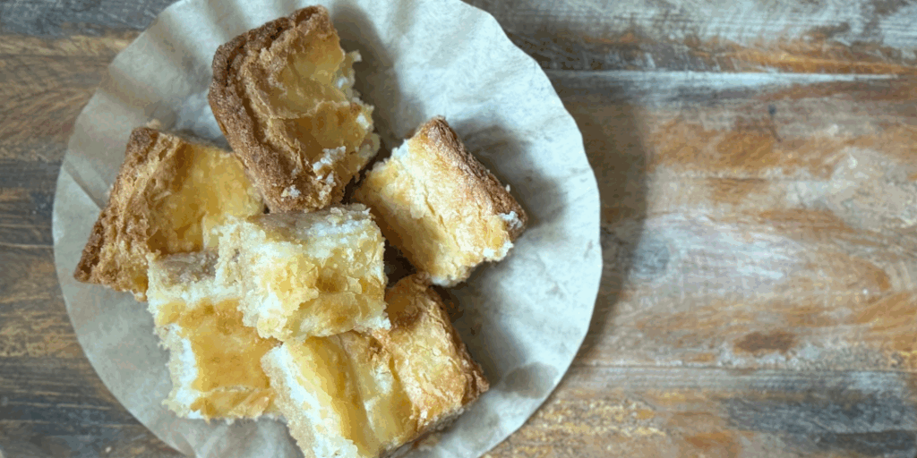 Homemade chess cake on a rustic wood table with a soft gooey topping