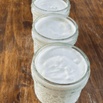 Open mason jars filled with creamy homemade yogurt
