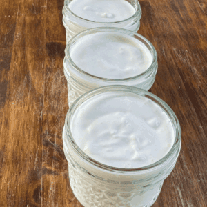 Open mason jars filled with creamy homemade yogurt
