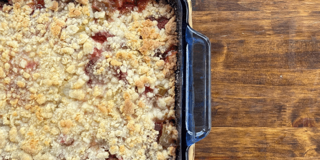 strawberry rhubarb crumble in a blue dish