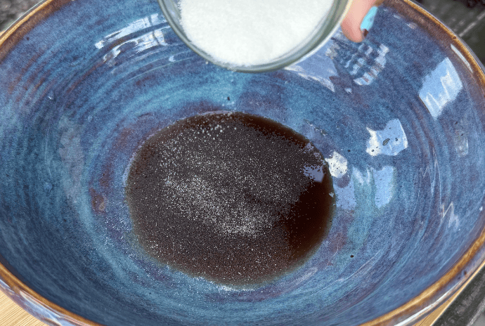adding gelatin to elderberry syrup to bloom it in a bowl