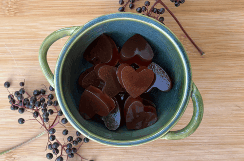 heart shaped elderberry gummies with elderberries on the step in a bowl