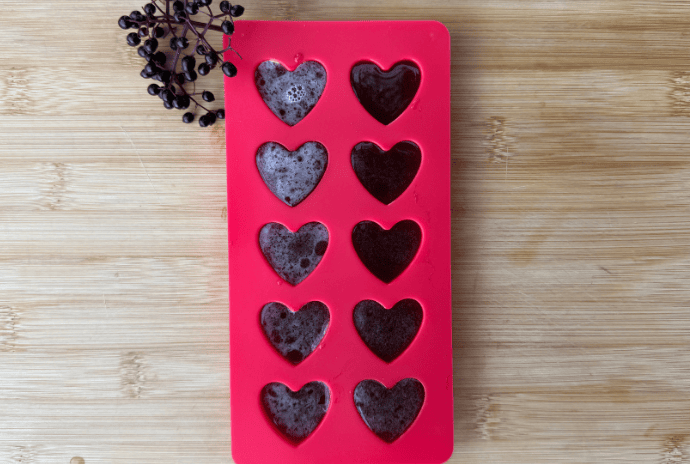 elderberry gummies in heart mold with fresh elderberries
