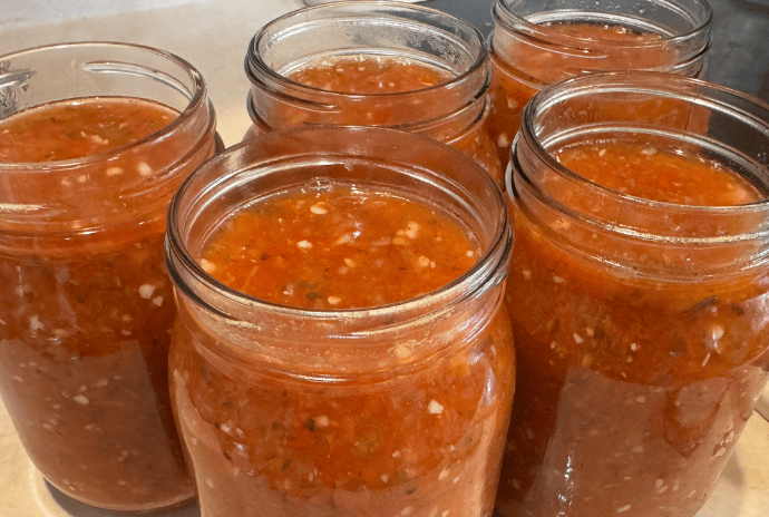 homemade salsa in jars on the counter