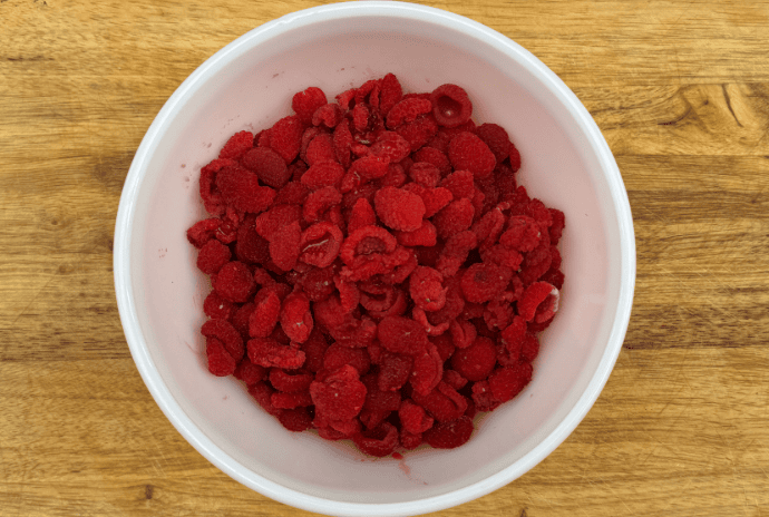 freshly picked thimbleberries in a white bowl
