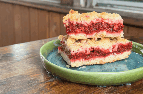 homemade thimbleberry crumble cut into bars on a plate