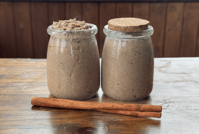 pumpkin spice tallow sugar scrub in jars with a cinnamon stick