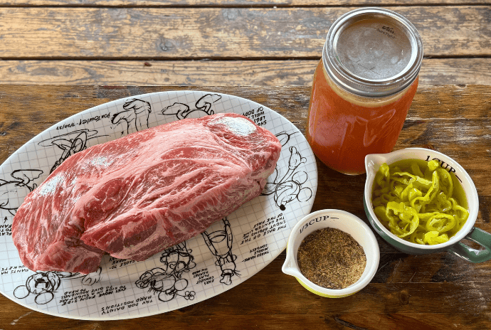 ingredients for italian beef, chuck roast, italian spices, pepperoncinis, homemade beef bone broth