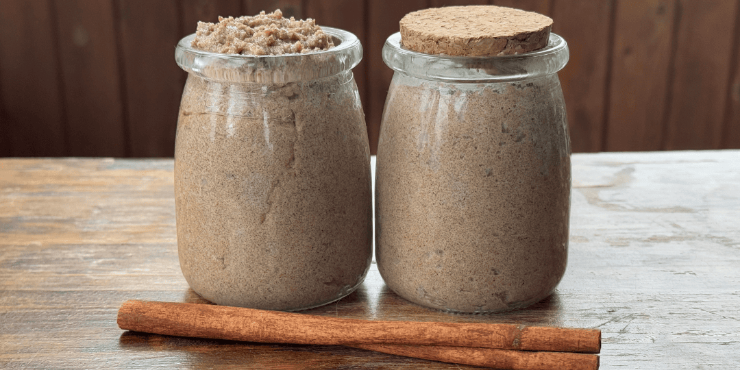 pumpkin spice tallow sugar scrub in jars with a cinnamon stick