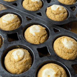 Baked Pumpkin Cream Cheese Muffins in a cast iron muffin pan