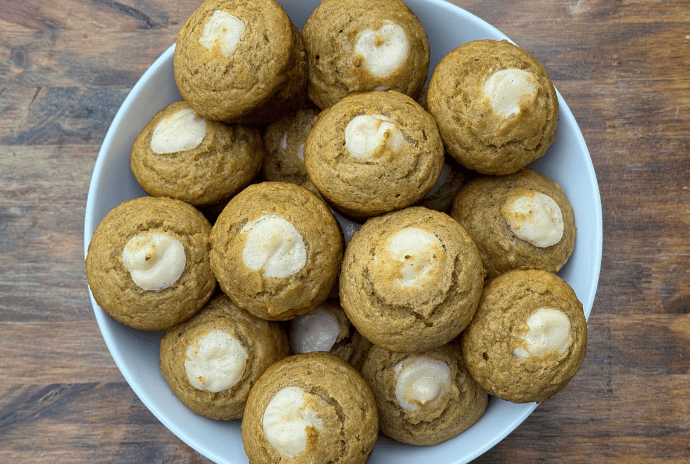 pumpkin muffins with cream cheese filling in a bowl