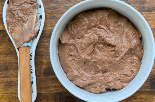 homemade whipped chocolate frosting in a white bowl