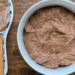 homemade whipped chocolate frosting in a white bowl
