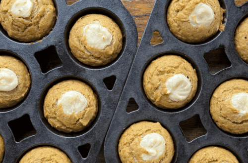 baked pumpkin cream cheese muffins in cast iron muffin pans