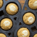 baked pumpkin cream cheese muffins in cast iron muffin pans