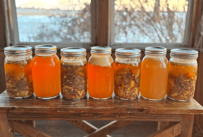 pressure canned quarts of bone broth and beef stew