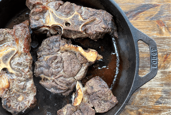 roasted soup bones in a cast iron skillet